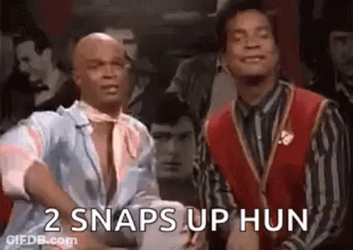 Two Men Standing Next To Each Other One In Red Vest GIF