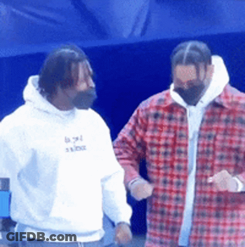 Two Men Standing Next To Each Other One Wearing A White Hoodie And The Other A Red Plaid Shirt GIF