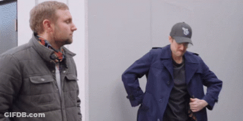Two Men Standing Next To Each Other One Wearing Chicago Hat GIF