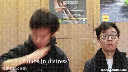Two Men Standing Next To Each Other One Wearing Glasses Covering Face GIF