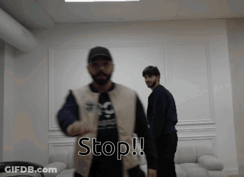 Two Men Standing Next To Each Other Saying Stop GIF