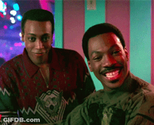 Two Men Standing Next To Each Other Smiling GIF