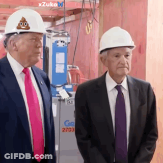 Two Men Standing Next To Each Other Wearing Hard Hats With A Poop On Them GIF