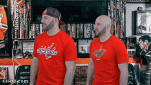 Two Men Standing Next To Each Other Wearing Red Capitals T-Shirts GIF