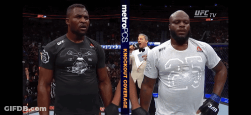 Two Men Standing Next To Each Other With A Metropcs Banner In The Background GIF