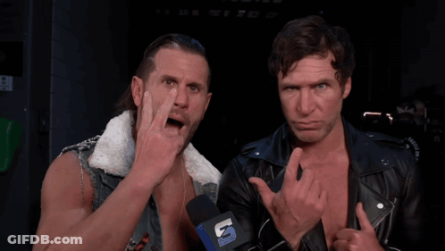 Two Men Standing Next To Each Other With A Microphone That Says U. GIF