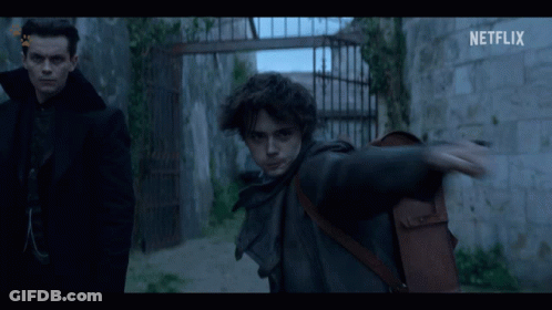Two Men Standing Next To Each Other With A Netflix Logo On The Bottom GIF