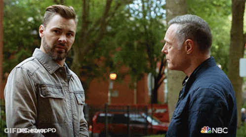 Two Men Standing Next To Each Other With NBC Logo GIF