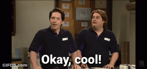 Two Men Standing Next To Each Other With Okay Cool Written On The Screen GIF