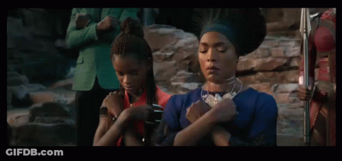 Two Men Standing Next To Each Other With One Wearing A Blanket That Says ' Mt ' On It GIF