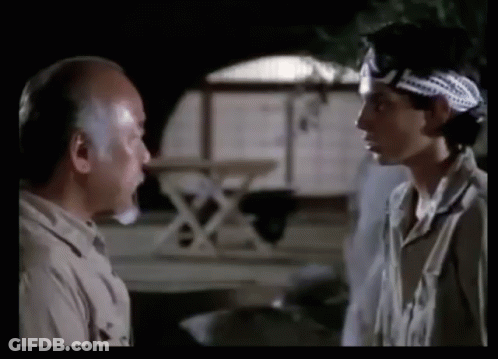 Two Men Standing Next To Each Other With One Wearing A Headband GIF