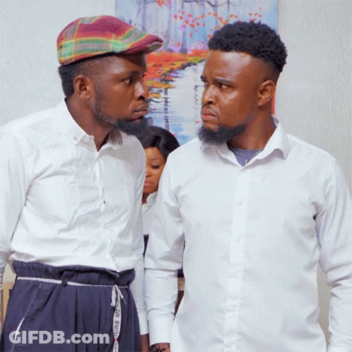 Two Men Standing Next To Each Other With One Wearing A Plaid Hat And The Other Wearing White Shirts GIF
