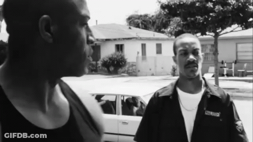 Two Men Standing Next To Each Other With One Wearing A Shirt That Says ' South Side ' On The Front GIF