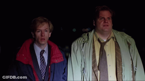 Two Men Standing Next To Each Other With One Wearing A Yellow Shirt And Tie GIF