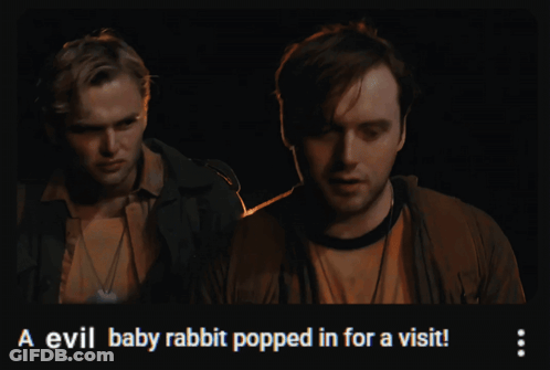 Two Men Standing Next To Each Other With The Words A Evil Baby Rabbit Popped In For A Visit On The Bottom GIF