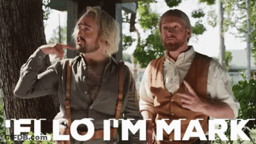 Two Men Standing Next To Each Other With The Words " Hello I 'M Mark " Written In White GIF