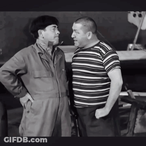 Two Men Standing Next To Each Other With Their Hands In Their Pockets GIF