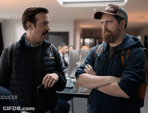 Two Men Standing Next To Each Other With Word Producer GIF