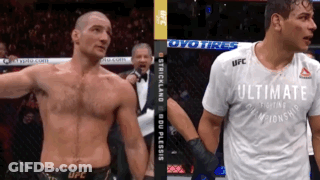 Two Men Standing Next To Each Other GIF