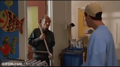 Two Men Standing Next To Fish On Wall GIF