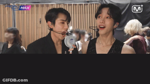 Two Men Standing Next To MT Sign GIF