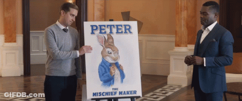Two Men Standing Next To Peter The Mischief Maker Poster GIF