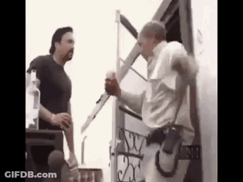 Two Men Standing Next To Trailer GIF