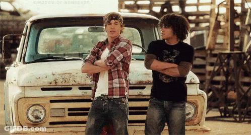 Two Men Standing Next To Truck With Arms Crossed GIF
