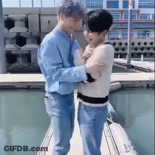 Two Men Standing On A Dock GIF