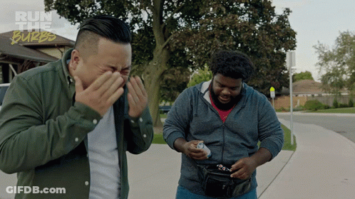 Two Men Standing On A Sidewalk With The Words Run The Burbs On The Bottom Right GIF