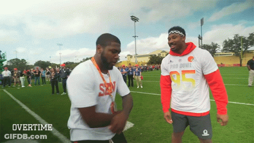 Two Men Standing On Field GIF