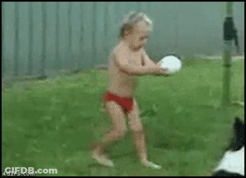 Two Men Standing On Grass Field GIF