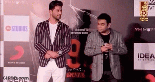 Two Men Standing On Red Carpet GIF