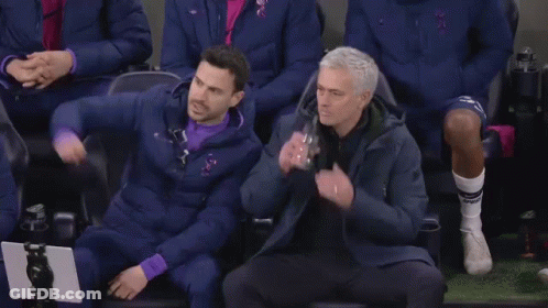 Two Men Standing On Soccer Field Talking GIF