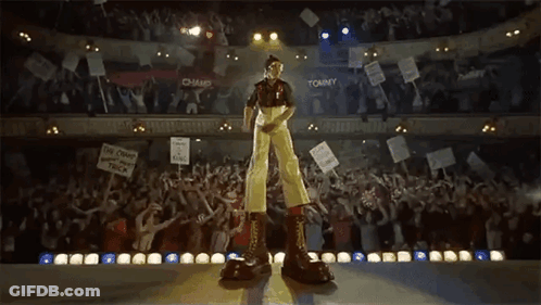 Two Men Standing On Track With Arms In Air GIF