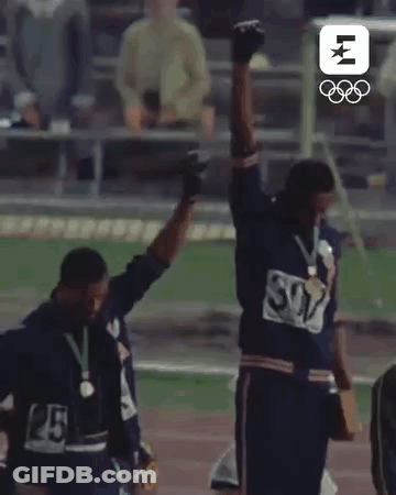 Two Men Standing On Track With Arms In Air GIF