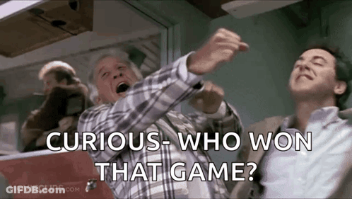 Two Men Standing, One Asking Curious Who Won That Game GIF