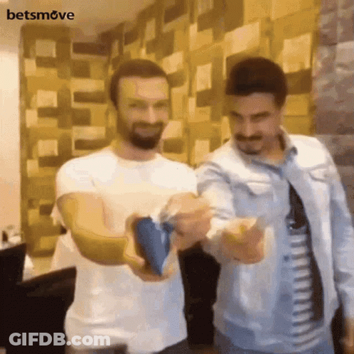 Two Men Standing One Holding Blue Object GIF
