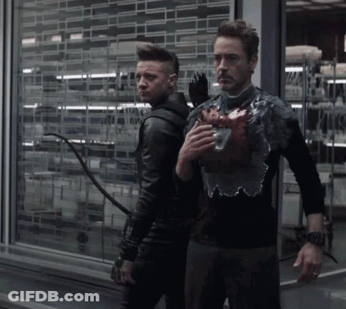 Two Men Standing One Holding Heart GIF