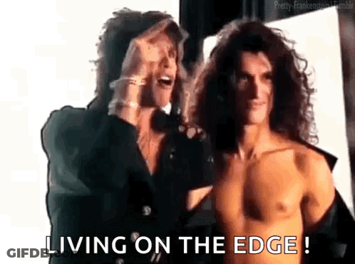 Two Men Standing One Shirtless GIF