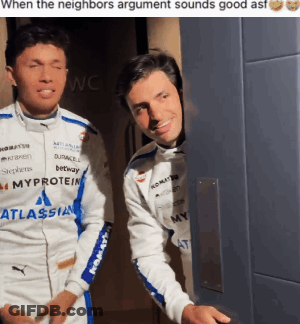 Two Men Standing, One Wearing Atlassian Jacket GIF