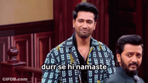 Two Men Standing One Wearing Durr Se Hi Namaste Jacket GIF