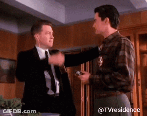 Two Men Standing One Wearing Headphones GIF