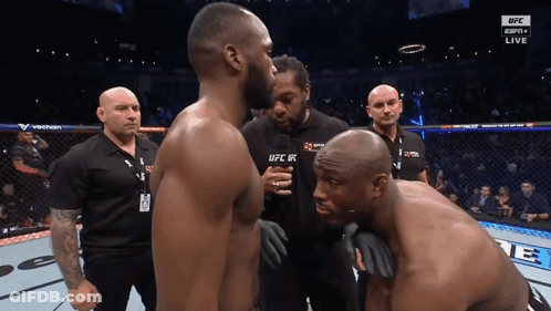 Two Men Standing, One Wearing UFC Shirt GIF