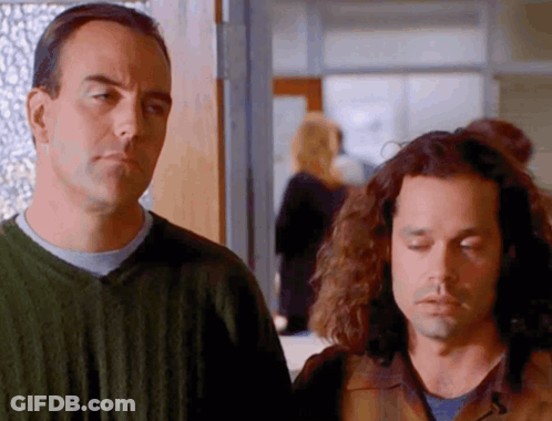 Two Men Standing One With Eyes Closed GIF