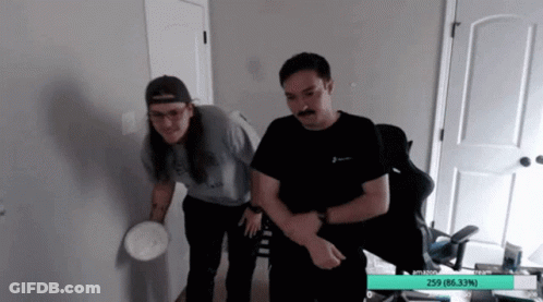 Two Men Standing One With Mustache One With Long Hair GIF