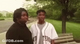 Two Men Standing Together In Park GIF