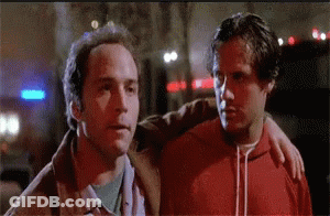 Two Men Standing Together One In Red Hoodie GIF