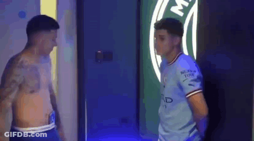 Two Men Standing Together GIF