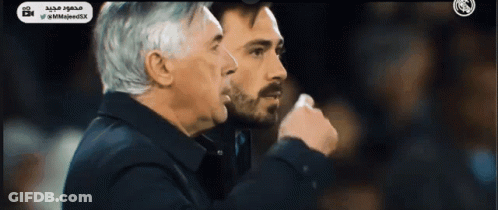 Two Men Standing With Arabic Writing GIF